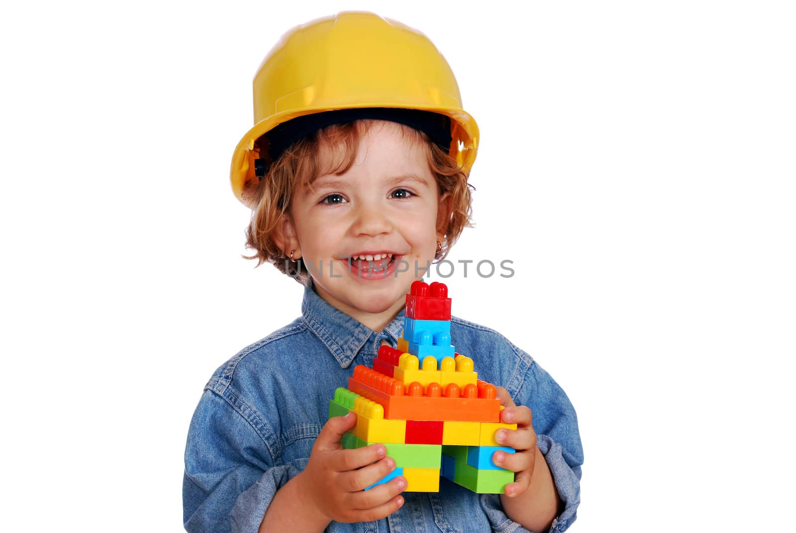 Little girl builder with toy block house studio shot