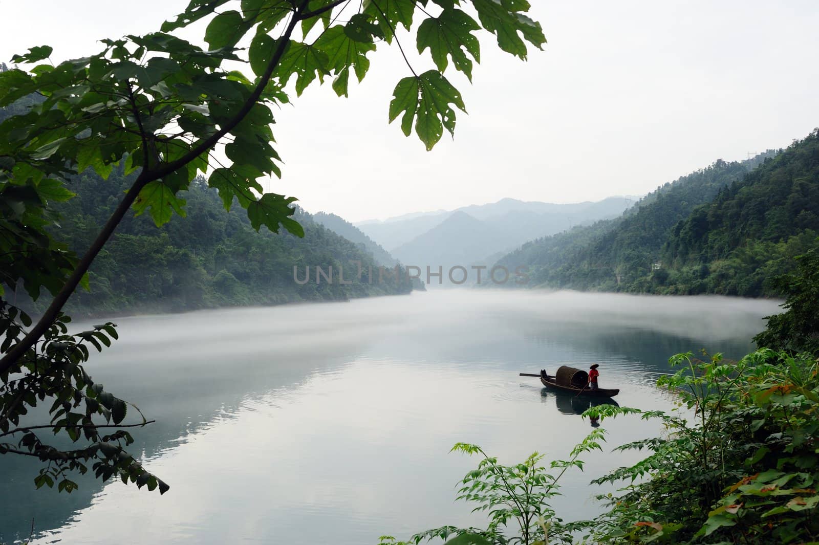 Fishing boat on the foggy river in hunan province of China