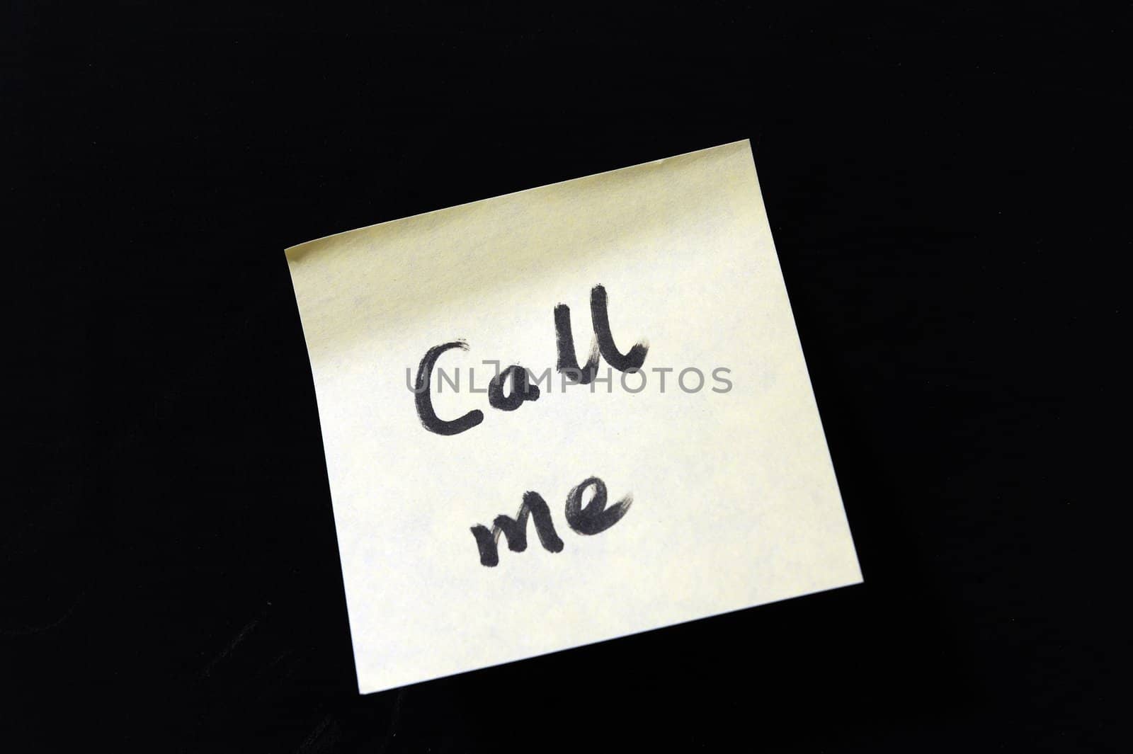 a notepaper which writes "Call me" on a chalkboard