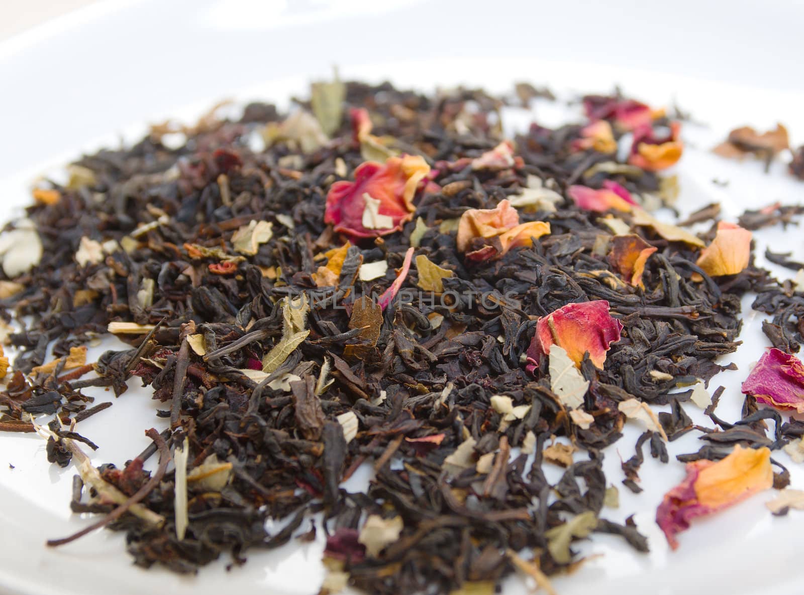  tea with petal of the rose and sunflower,in studio shoton white background 