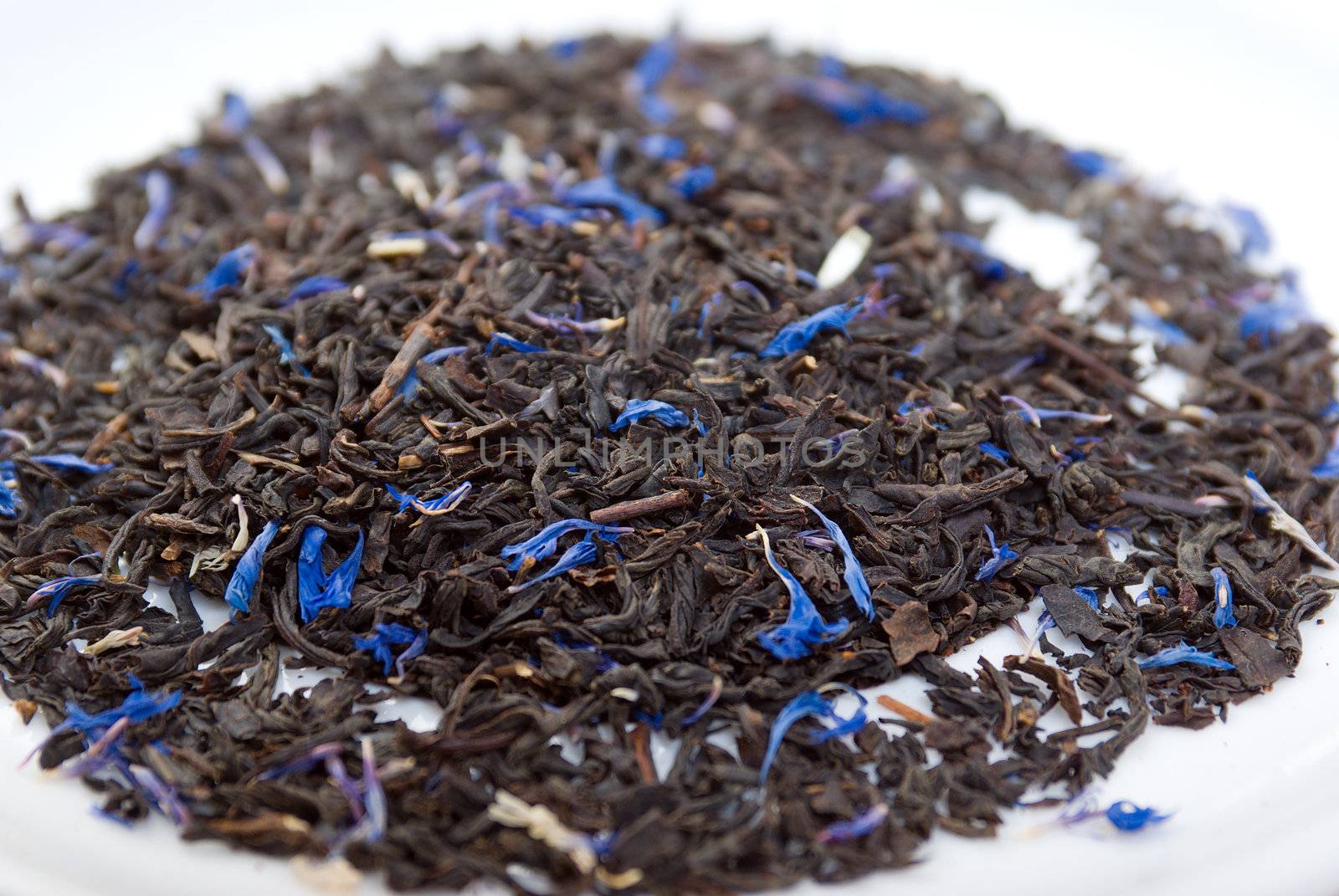 Earl Grey  teawith sheet cornflower and  bergamot,in studio shoton white background 
