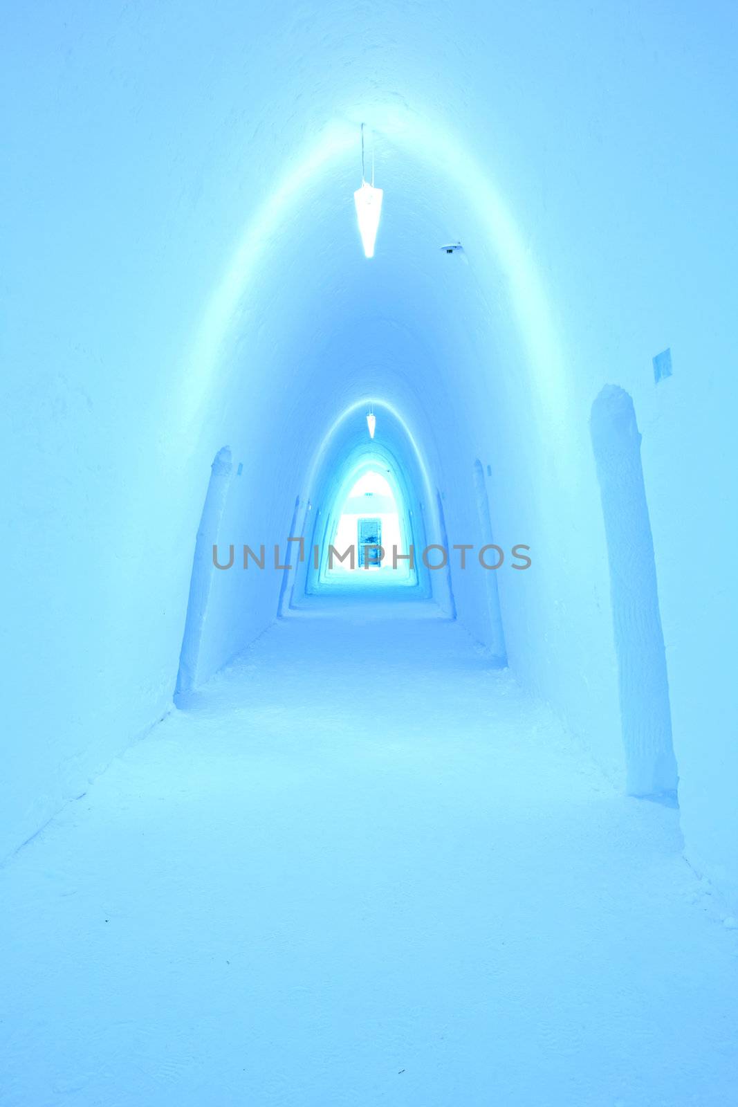 Colorfully illuminated corridor in an ice hotel
