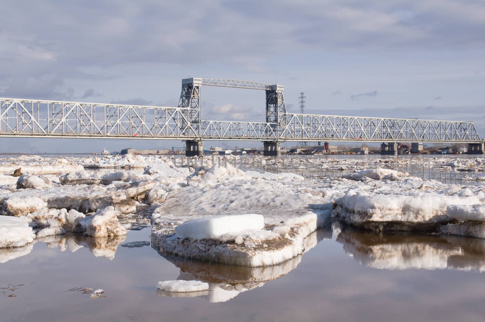 Railway bridge by springtime.Driving of ice goes On river