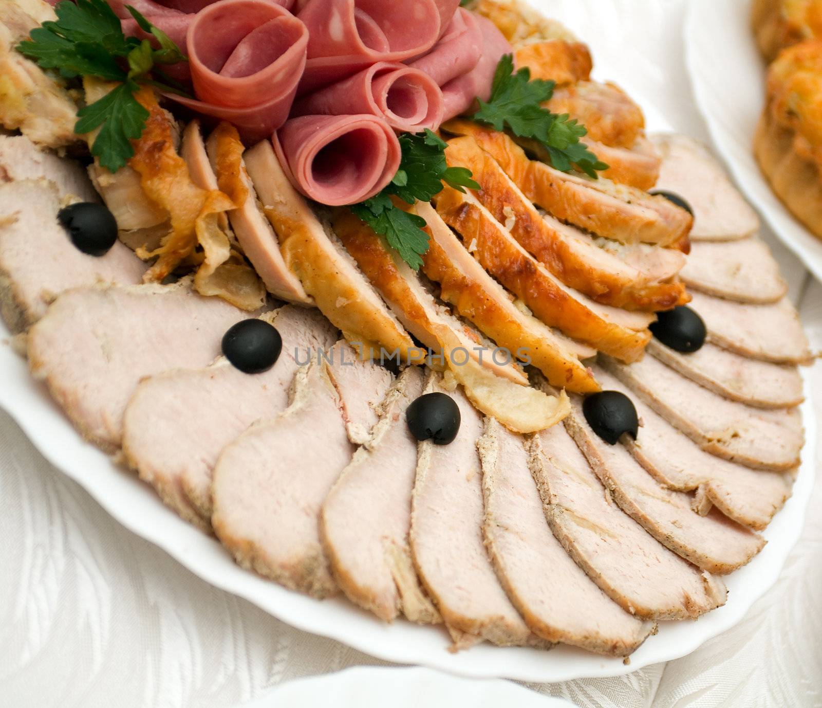 Beautiful sliced food arrangement with some vegetables. Shallow depth-of-field. 
