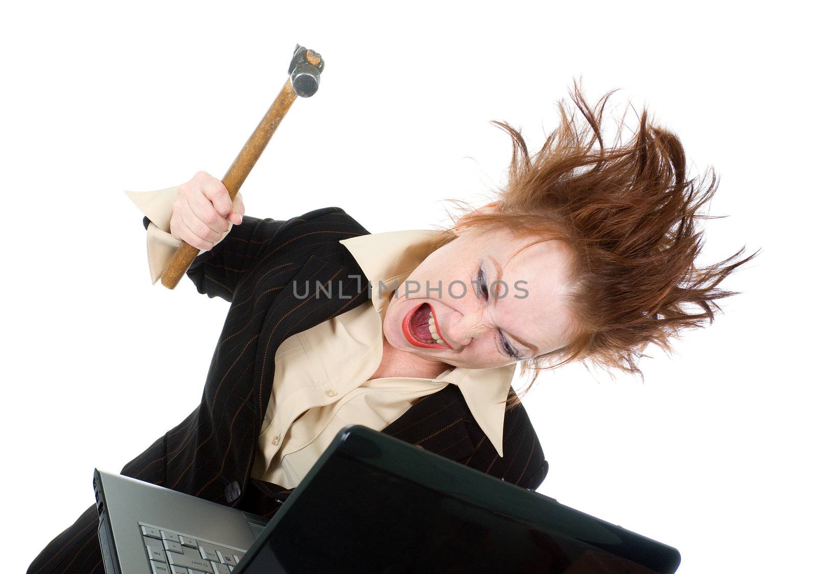 angry and stressed businesswoman smashing her laptop with a hammer
