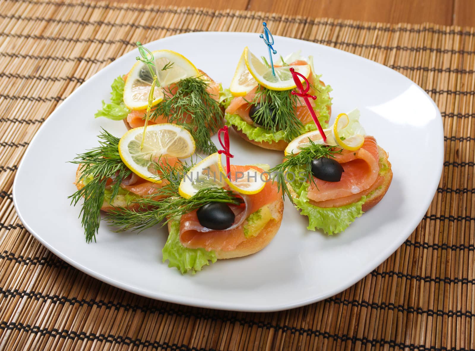   Canapes with Smoked Salmon and lemon on plate