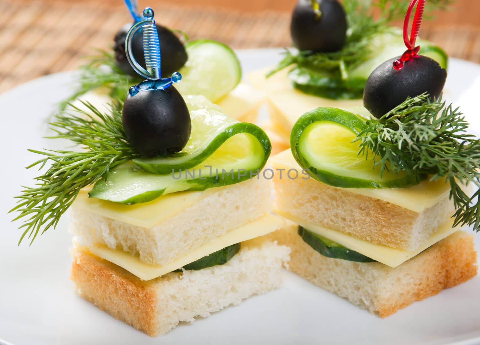 Canape with cheese and cucumber. Shallow depth-of-field. 