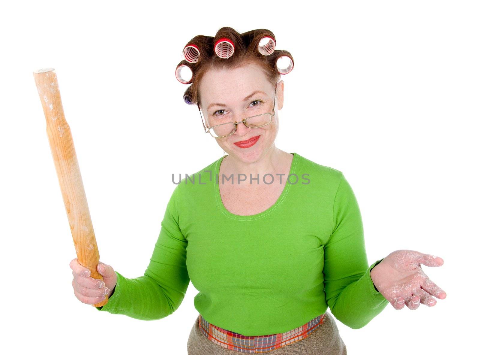 Angry crazy  housewife in hair rollers is holding.Angry look on face. Studio, white background. 