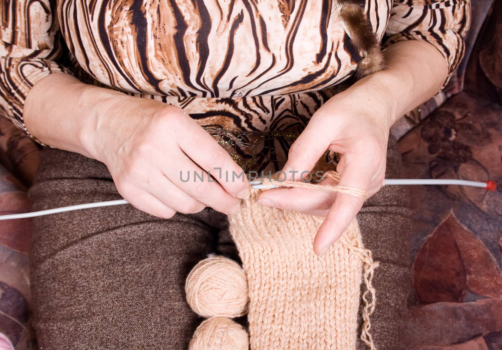 Close-up of an old woman's hands as she knits.
