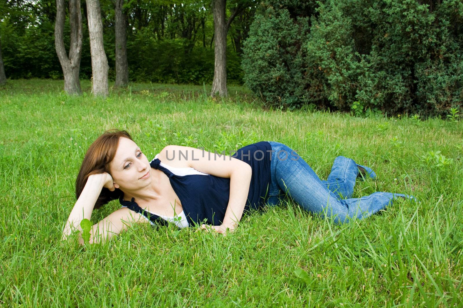 Beautiful girl lying on the grass enjoying the peace by Irina1977