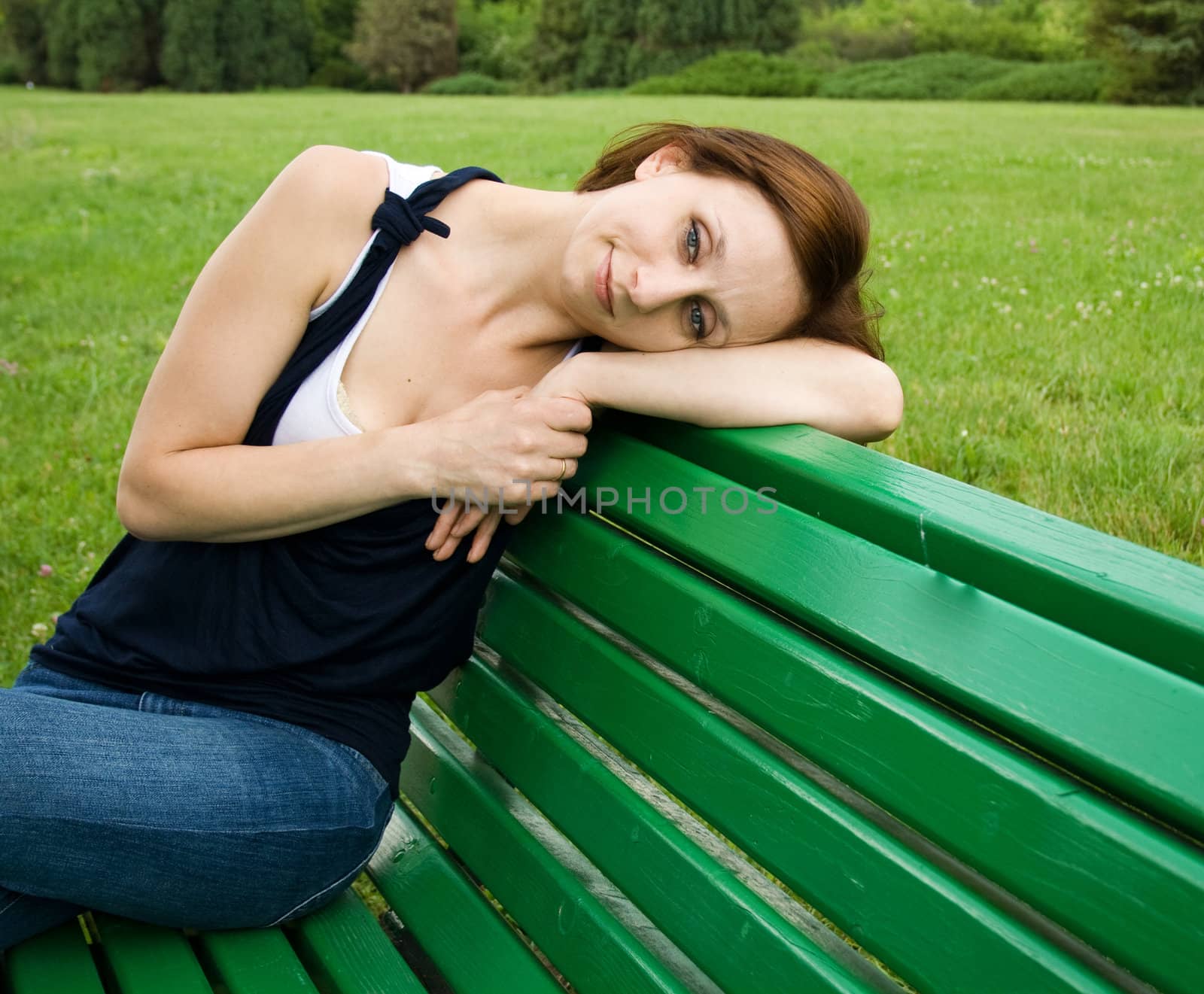 Girl in thought sitting on a park bench