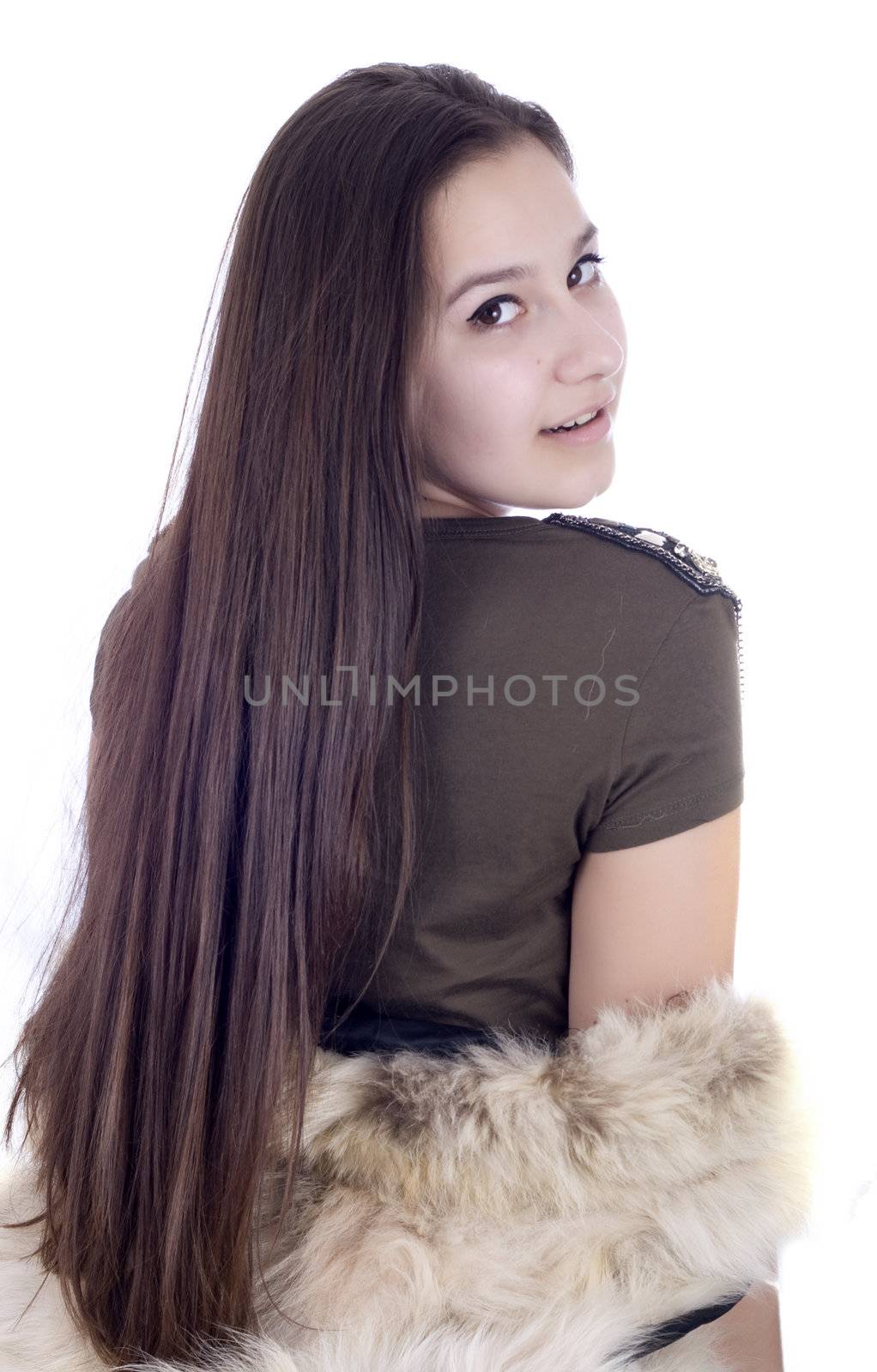 The young beautiful girl in a fur coat isolated on white
