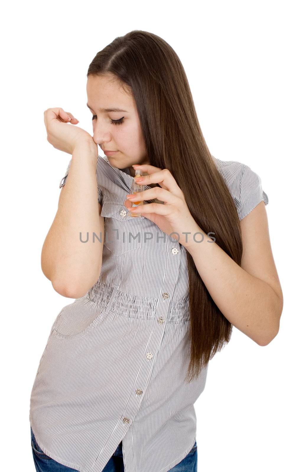 Fashion woman applying perfume on her waist over white.
