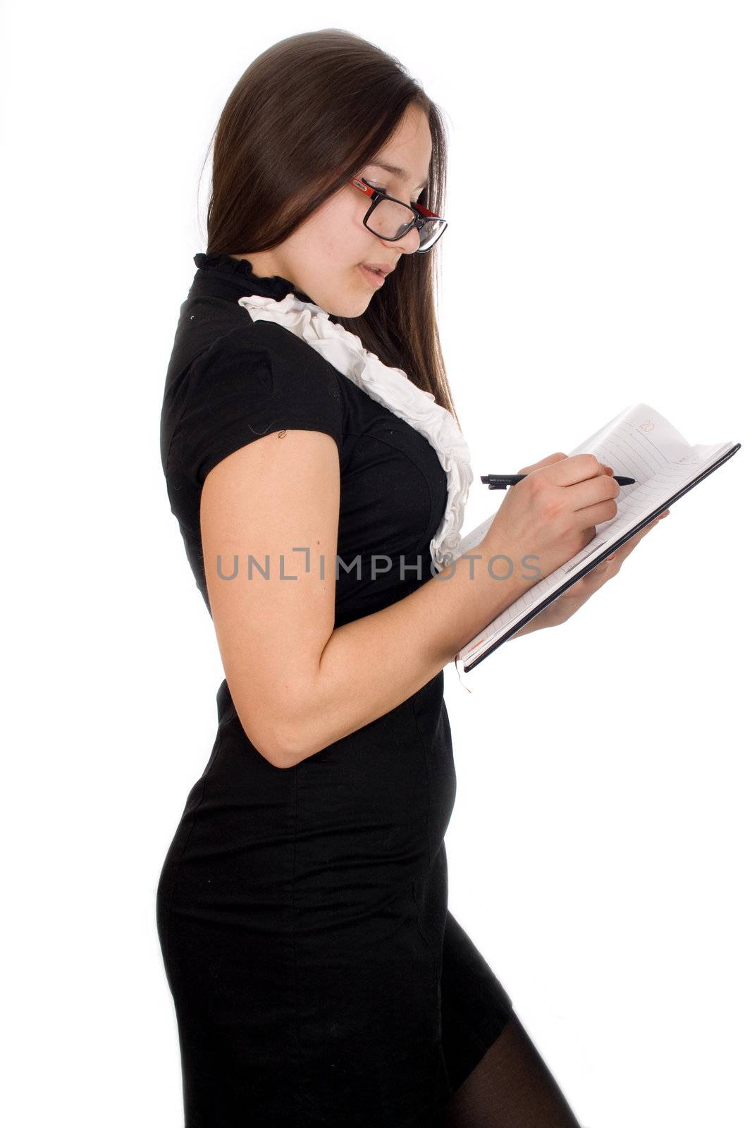 Thoughtful young girl holding pen and notepad, isolated on white background