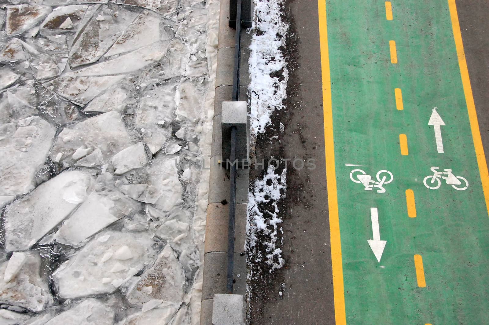 Green bicycle path at winter riverside road, Moscow, Russian Federation