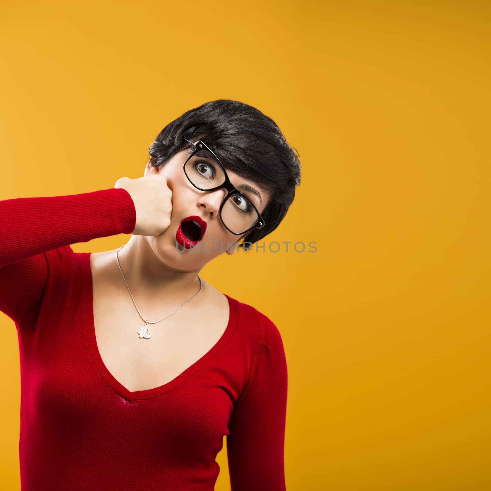 Nerd girl punching himself, against a yellow background