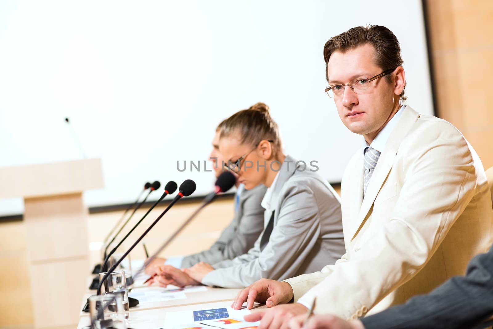 businessmen communicate at the conference, man looking at the camera