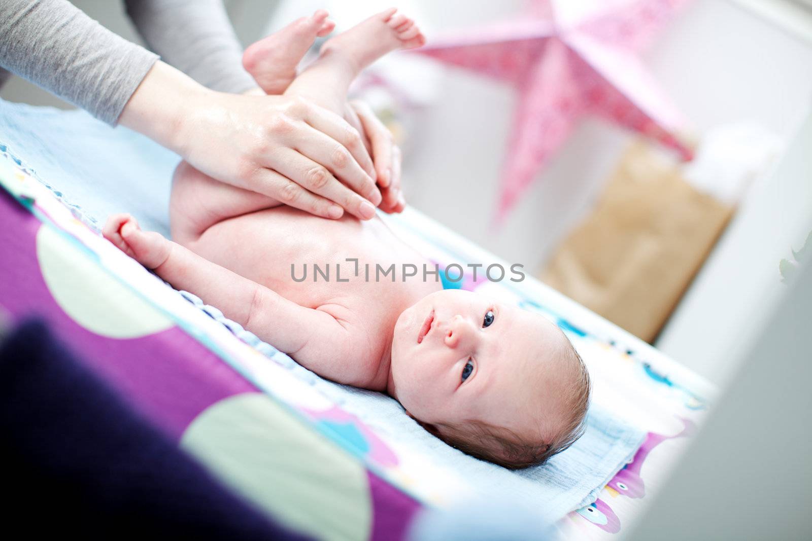 Newborn baby having a nappy change by langstrup