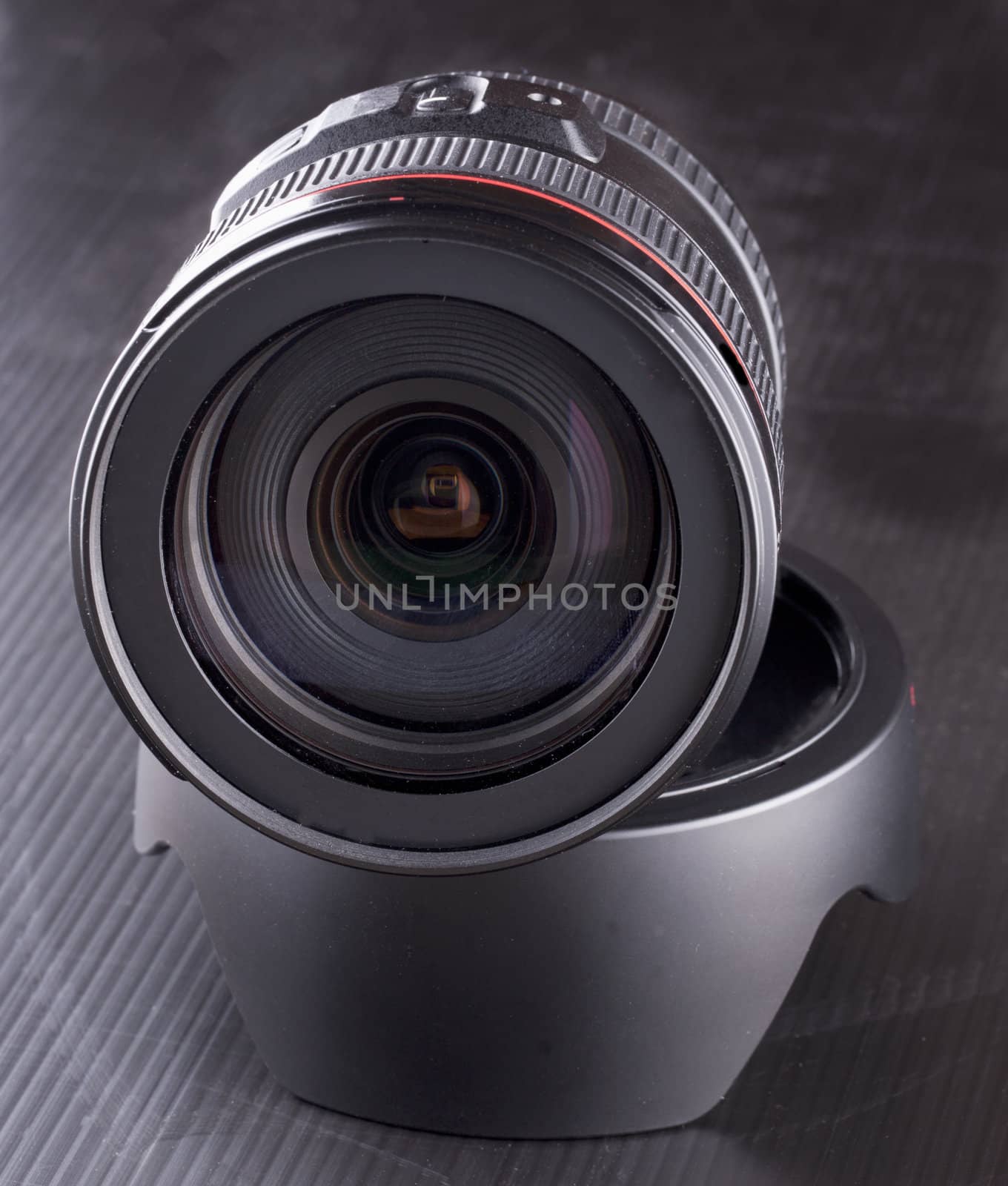 A black lens standing over hood, over black background