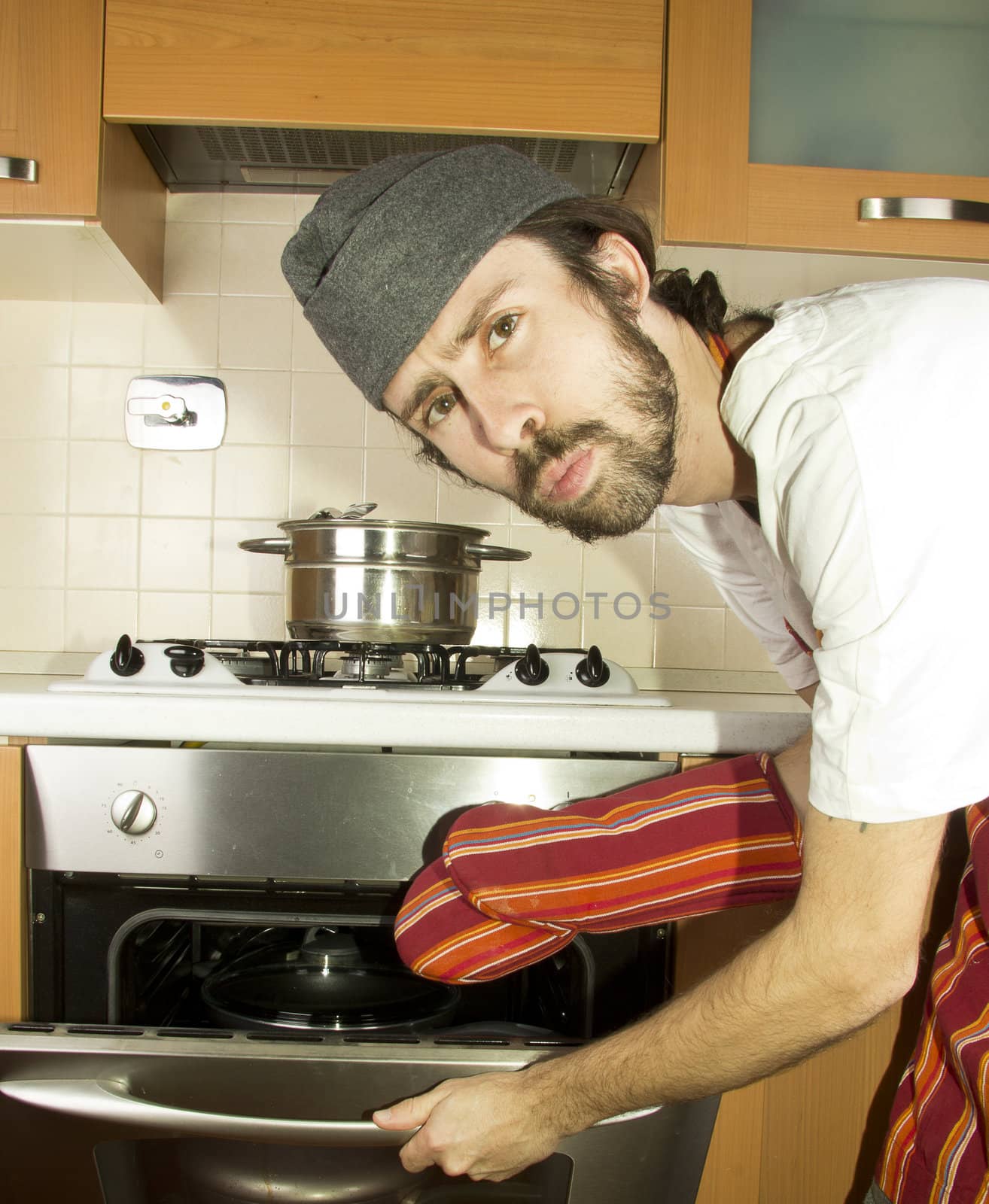 portrait of male chef with oven