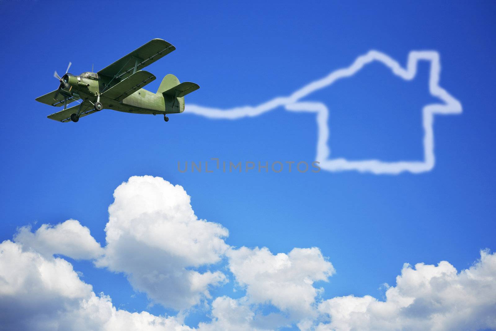 The airplane and house on a background of the blue sky