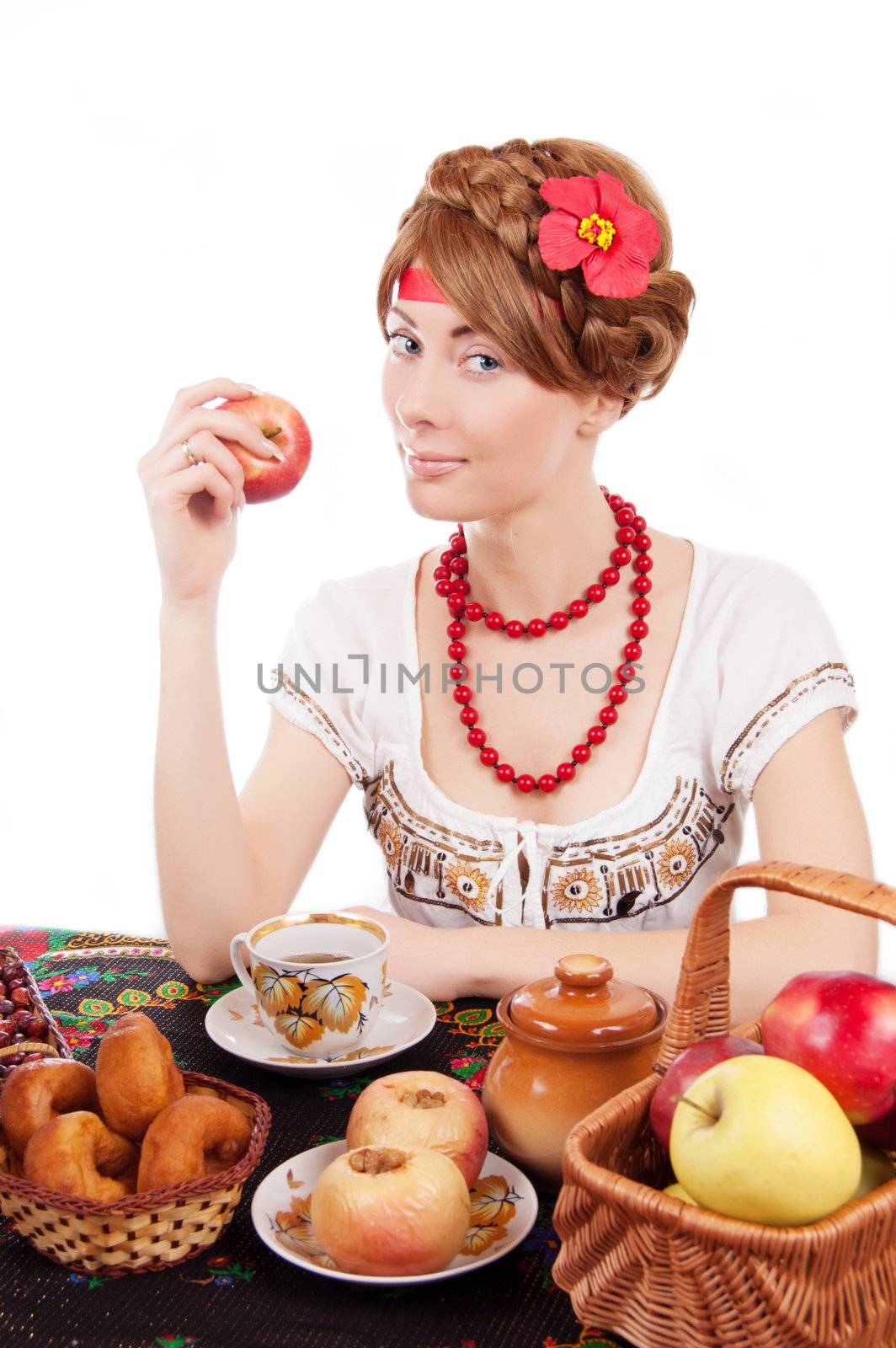 Russian woman eating apples at table over white