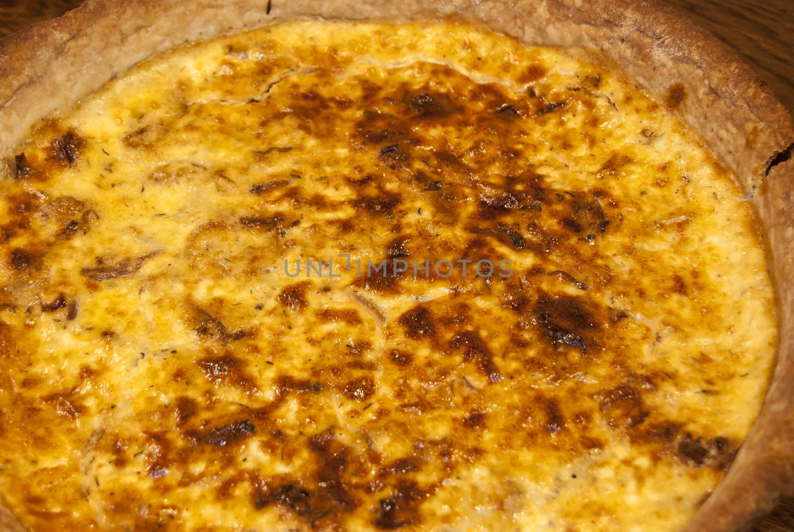 Homemade quiche pie with eggs, cheese,onion closeup