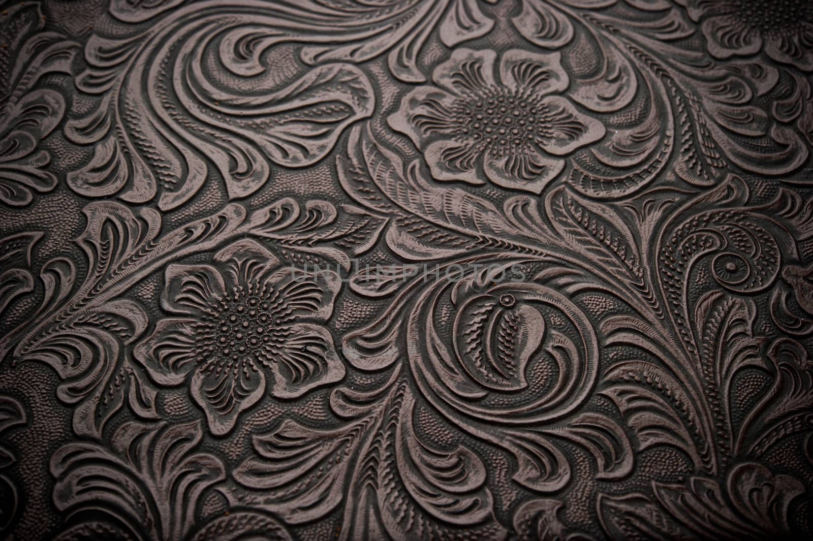 Image of dark brown floral design engraved leather