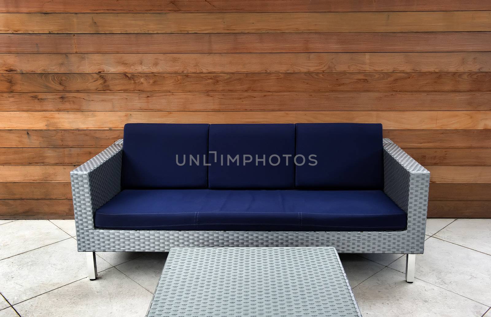 Image on a patio of a contemporary blue and silver outdoor couch