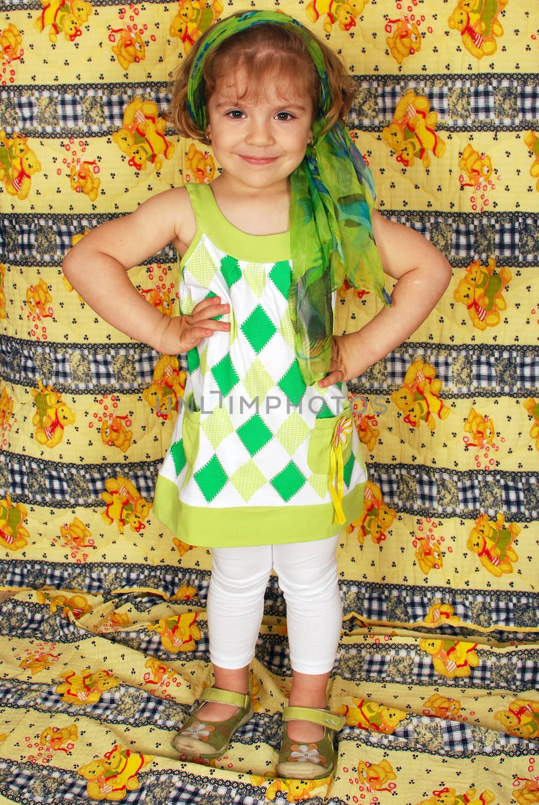 Beauty little girl posing with green headscarf