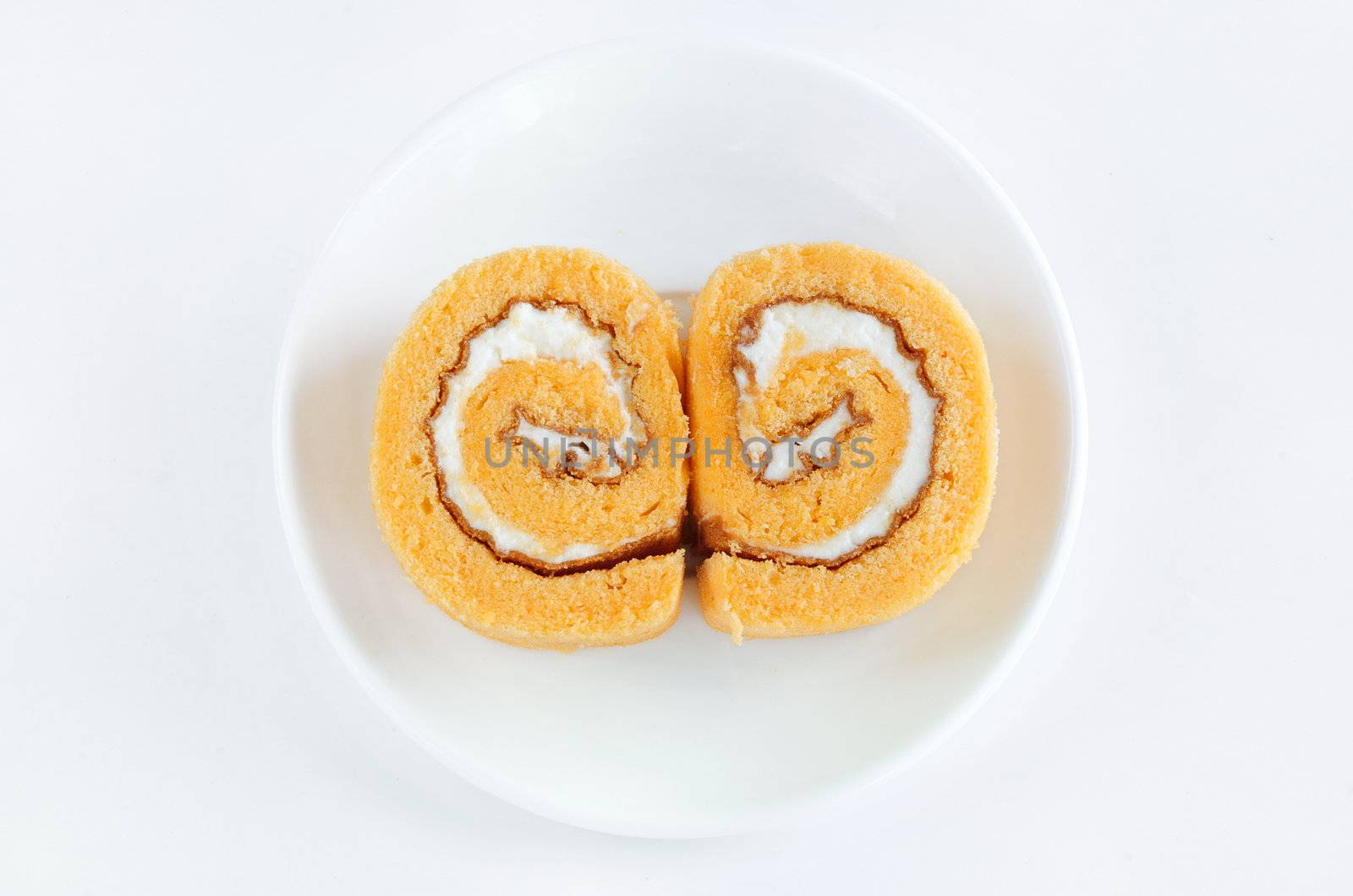 roll cake with cream on white