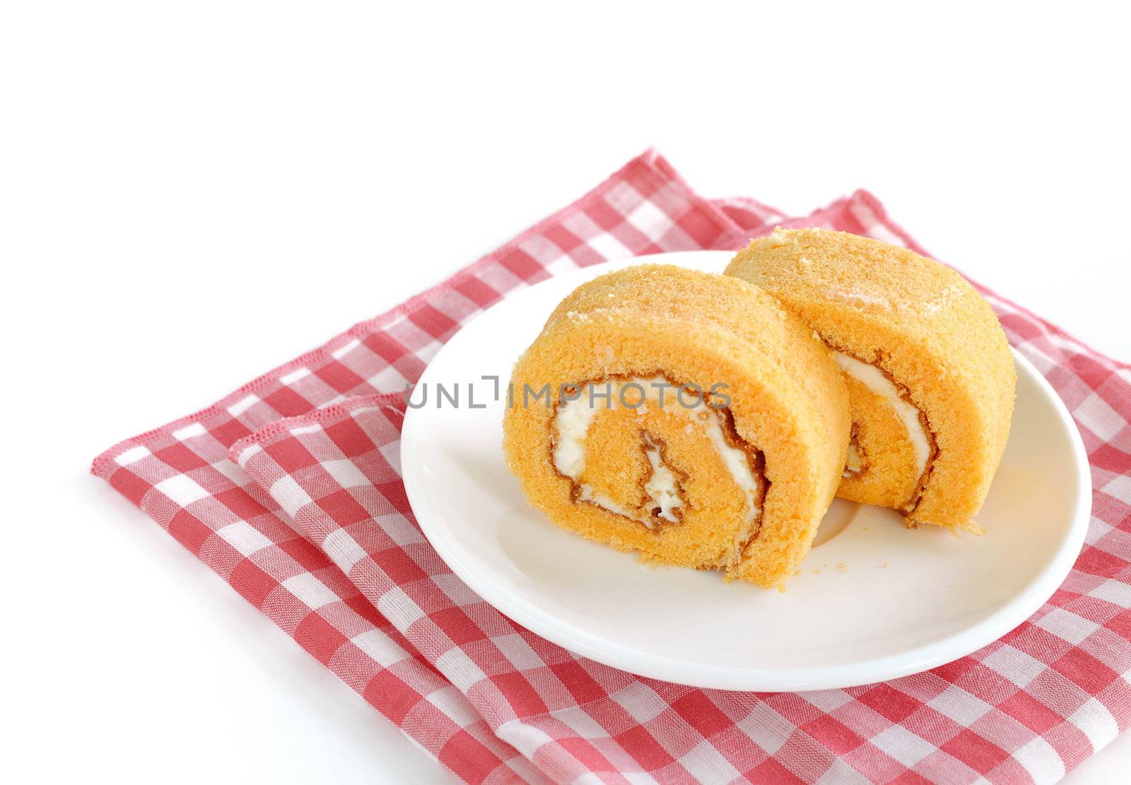 roll cake with cream on white
