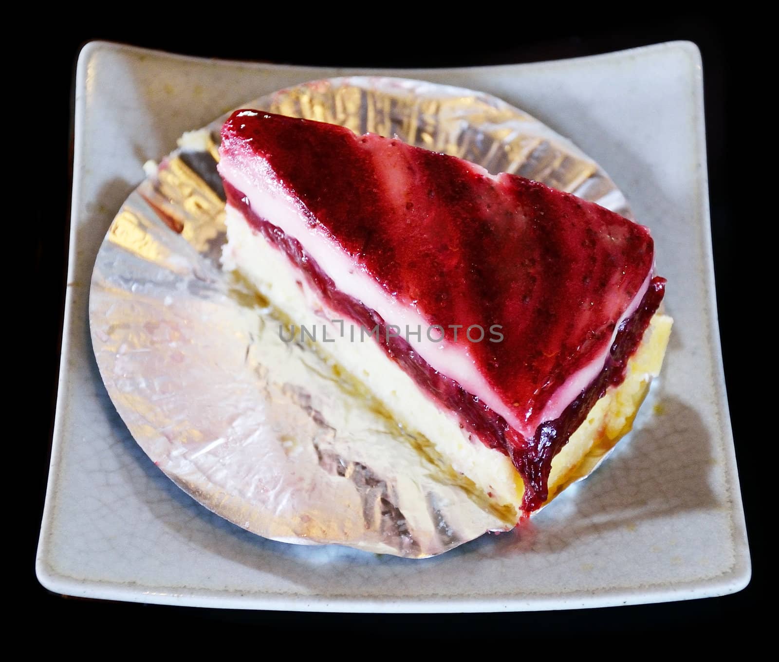 Strawberry cheesecake isolated on black background