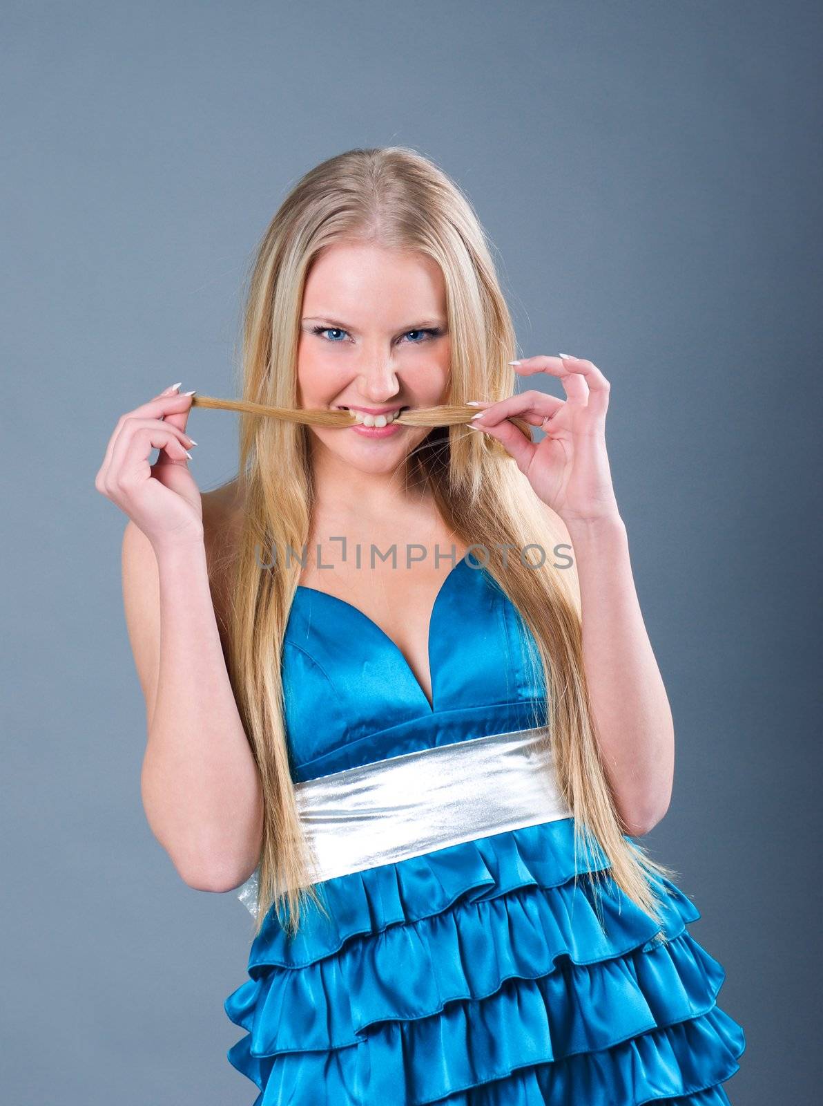   Attractive girl in blue dress, studio shot  