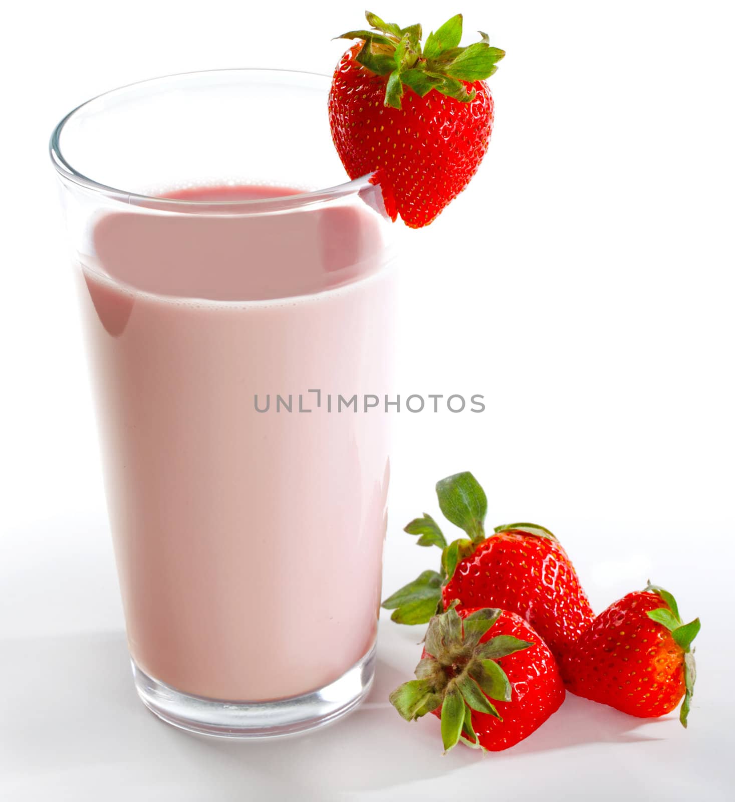 Strawberry milkshake on a tall glass on a white background