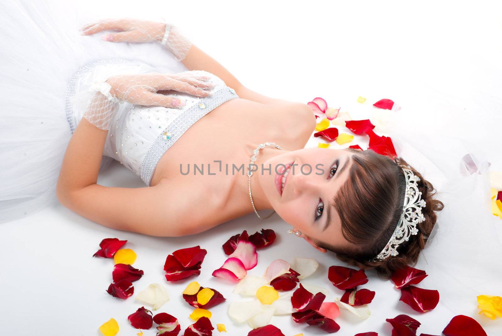 Beautiful sexy bride  on  floor among red rose petals  by Fanfo