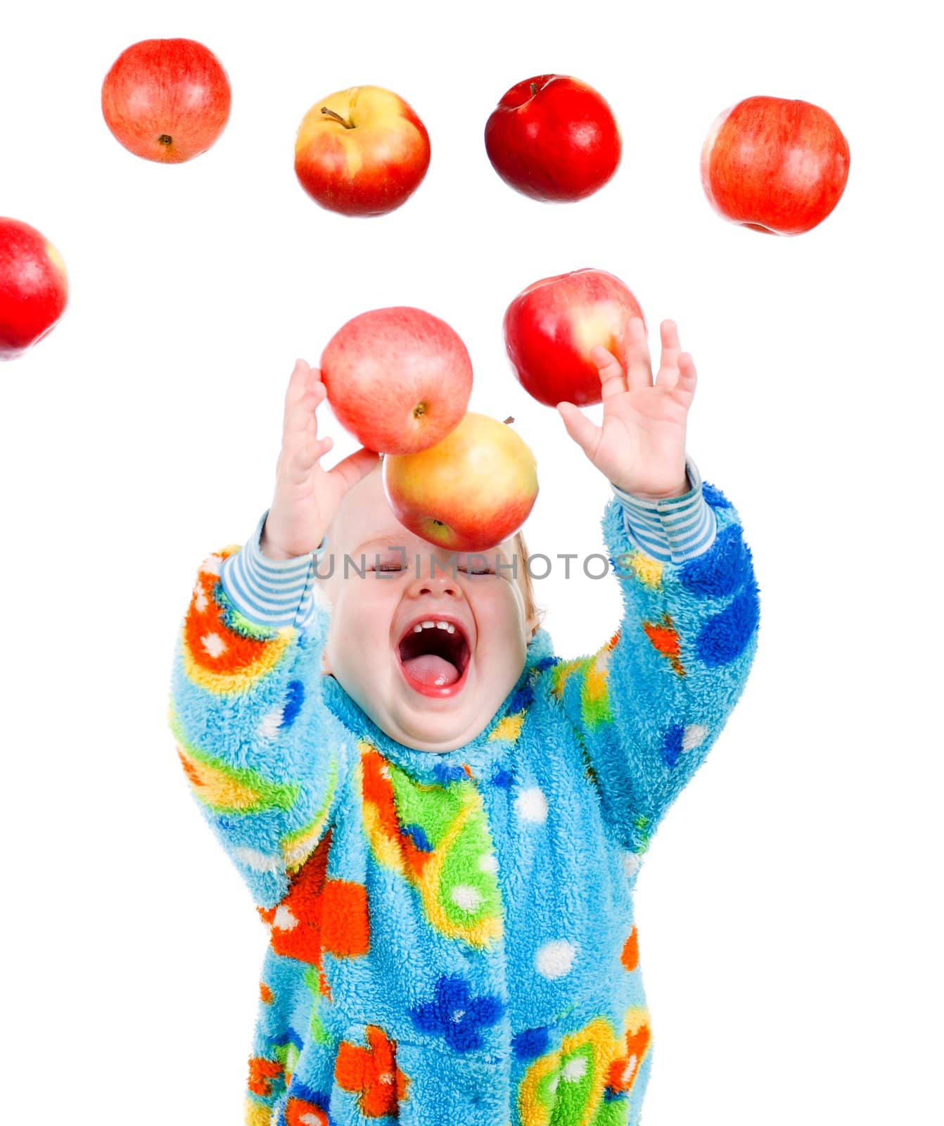 Little baby girl caughts flying apple  .isolated on white background