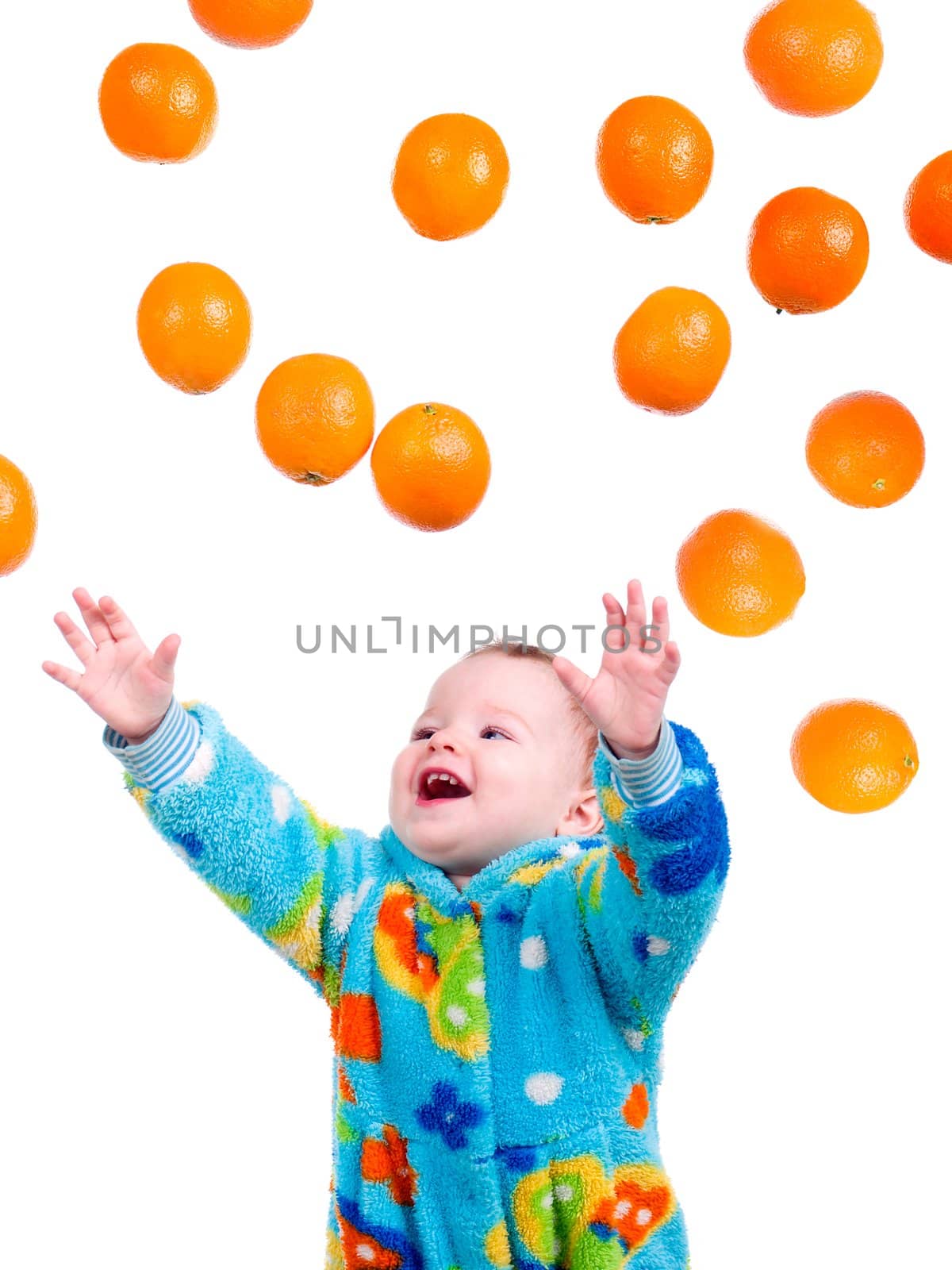 Little baby girl caughts flying oranges  orange .isolated on white background