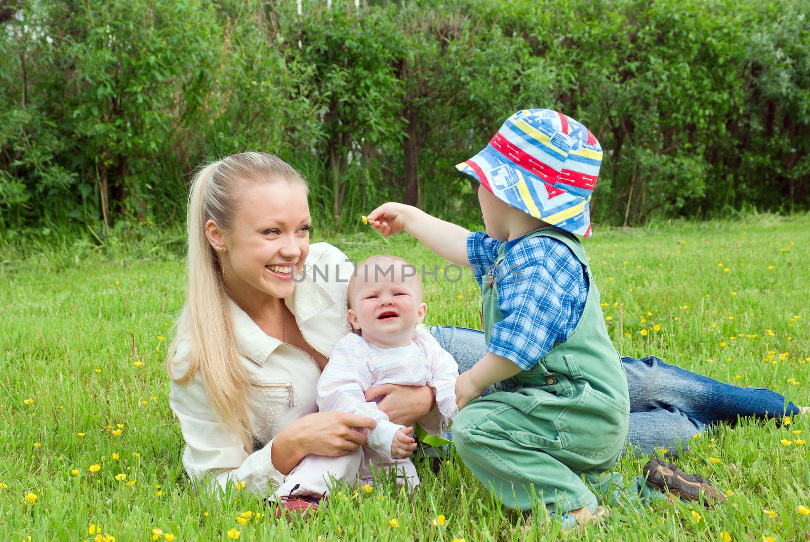 mother with children on meadow  by Fanfo