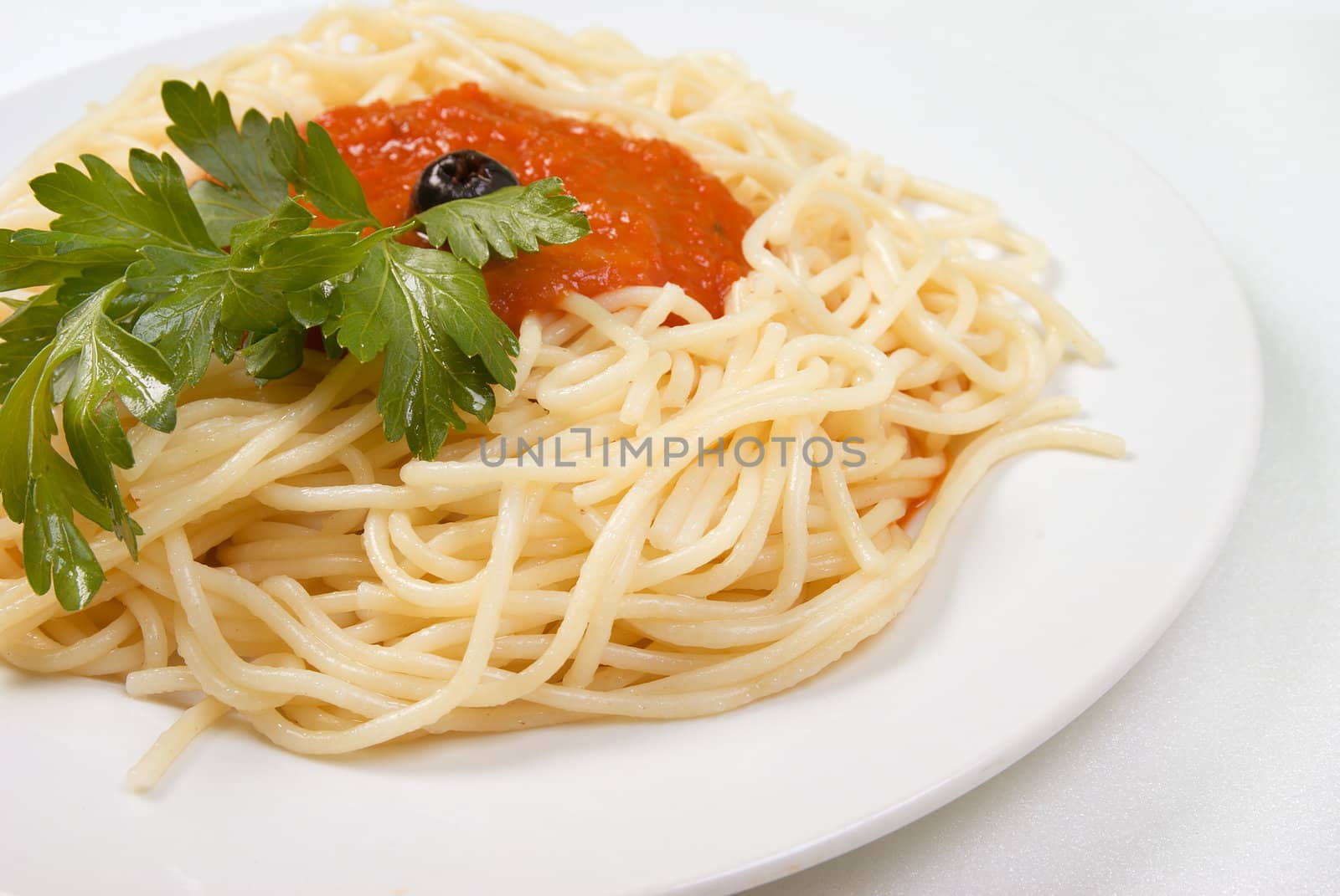 Spaghetti with tomato sauce and parsley.Italian kitchen