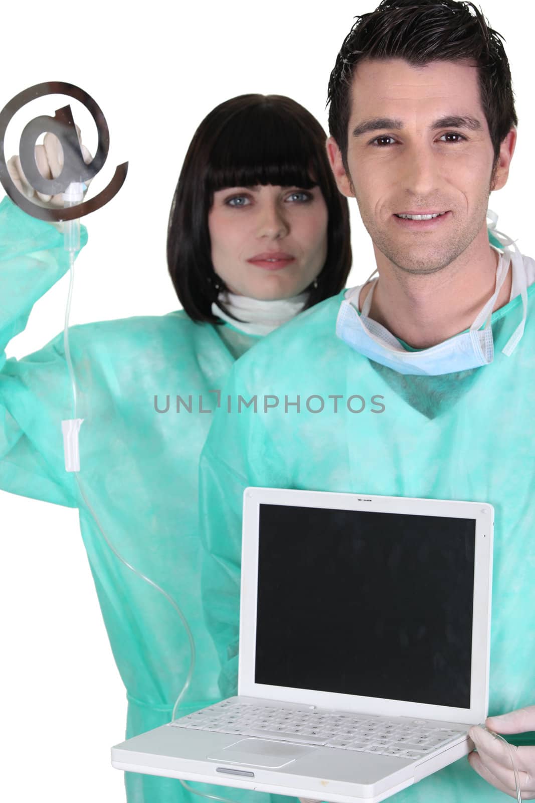 medical workers holding a laptop and an at sign