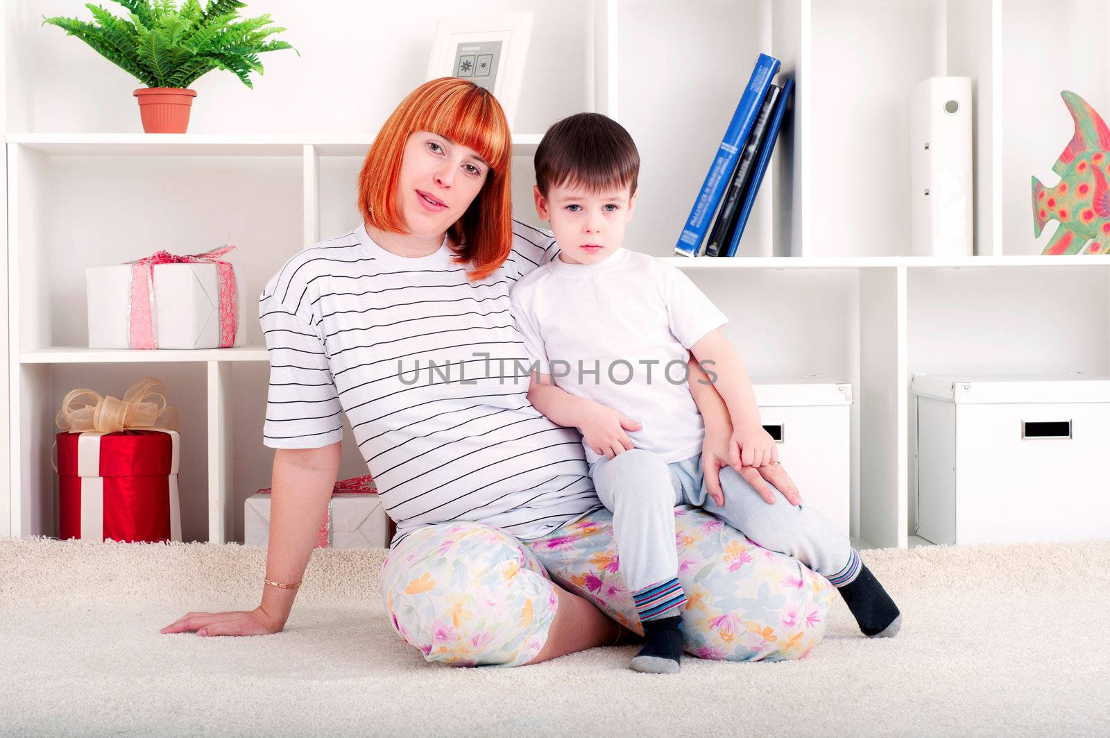 portrait of a pregnant woman and her son, at home