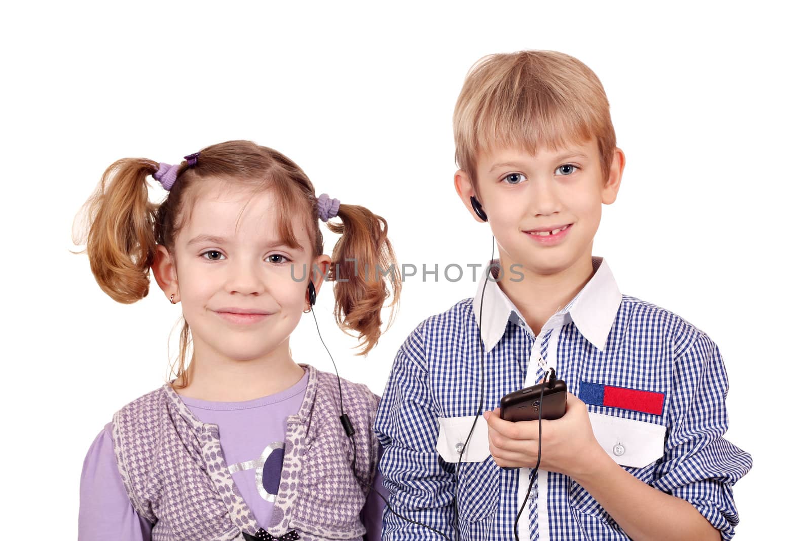 little girl and boy listening music on smart phone by goce