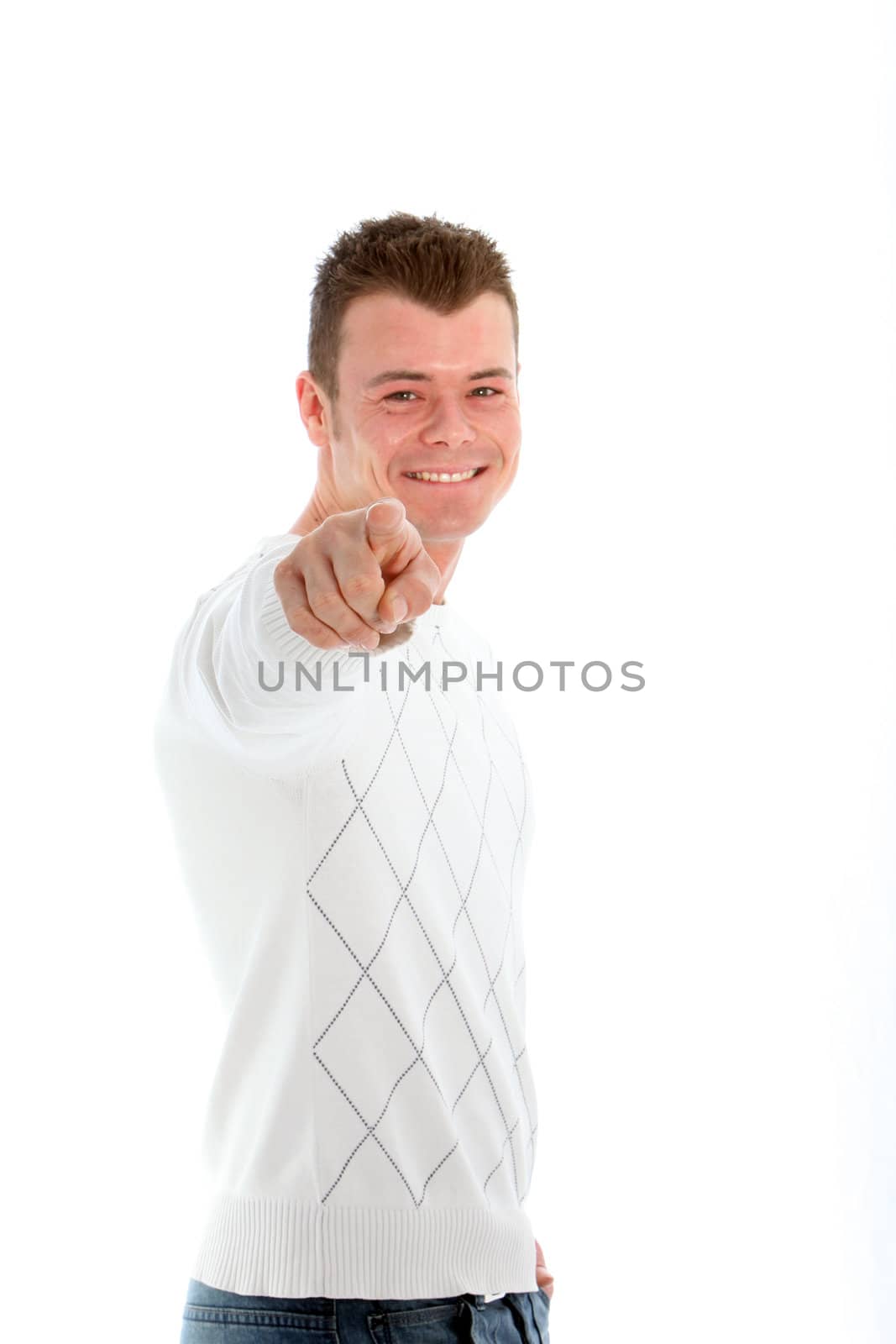 Smiling handsome young man pointing directly at the camera with his finger, upper body studio portrait on white