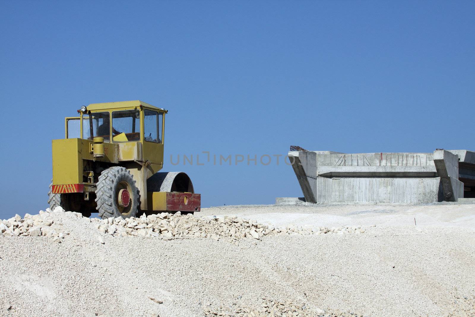 Road roller working at road construction site