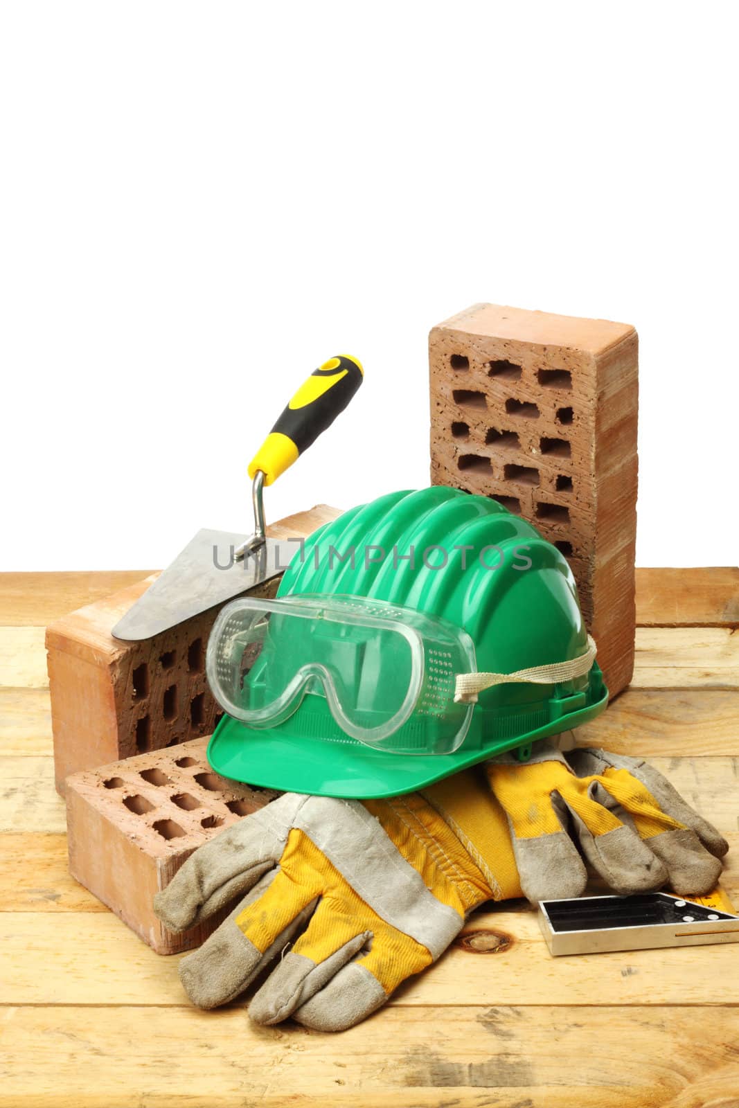 Bricks, trowel and helmet on work place 