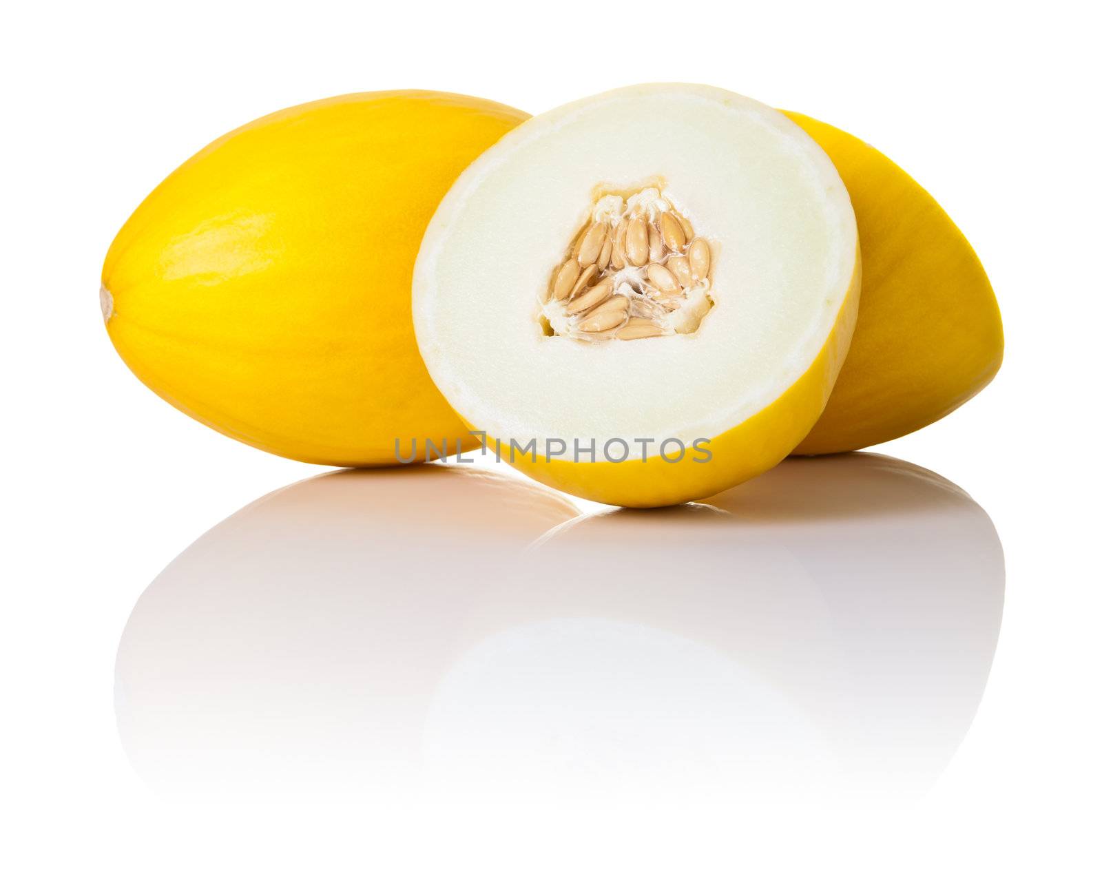 Two honeydew melons on white background. One sliced in half and second whole, copy space