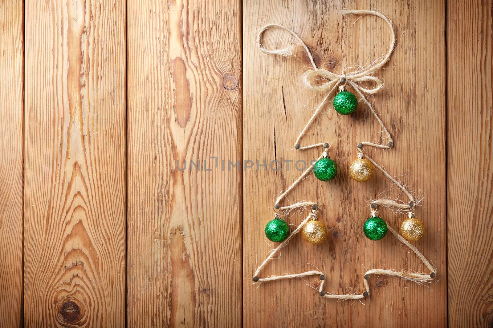 Christmas tree with balls on wooden background with copy space