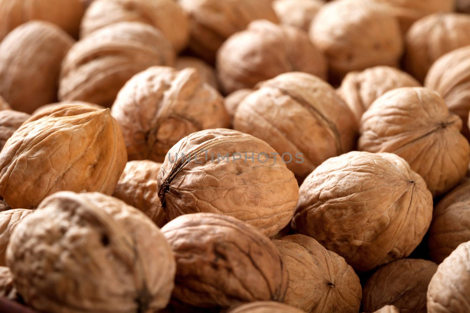 Plenty of whole walnuts close-up for background