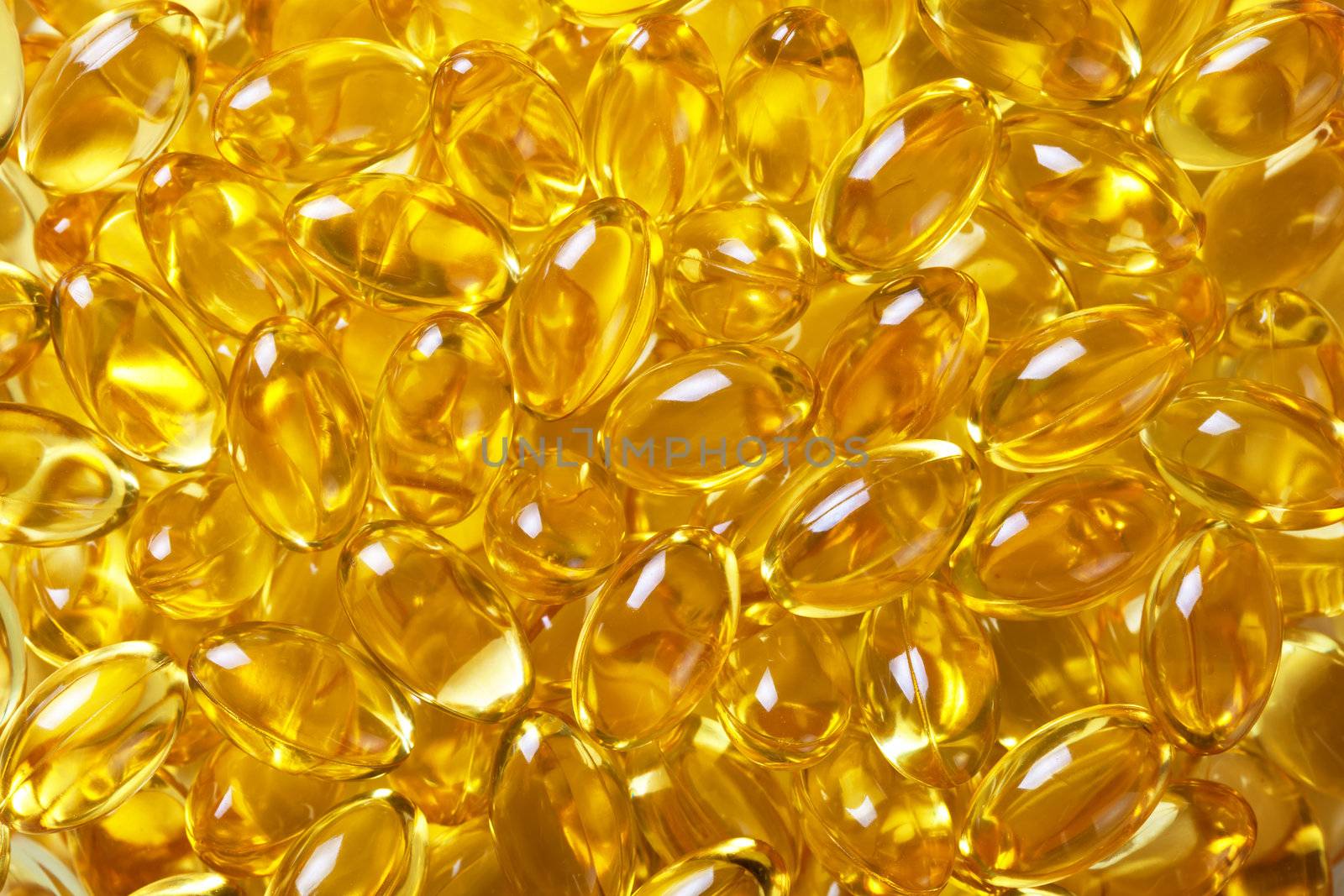 Cod liver oil pills background. Macro shot 